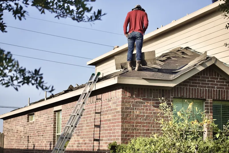 Professional roofer working on a residential roof in Perryton